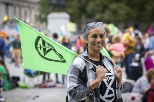 woman-holding-flag-grey-hair-rediscover-passions-post-retirement-retiree-later-life-60-aging-purpose-reason-wellbeing-supportiv